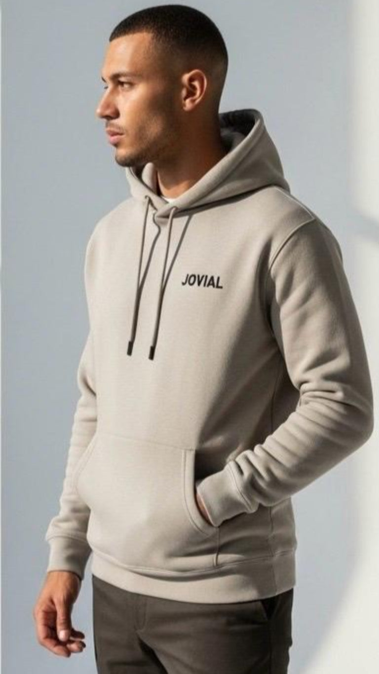 Man wearing a gray hoodie with 'JOVIAL' branding against a light background