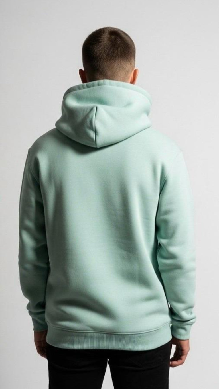 Person wearing a light green hoodie from behind on a white background