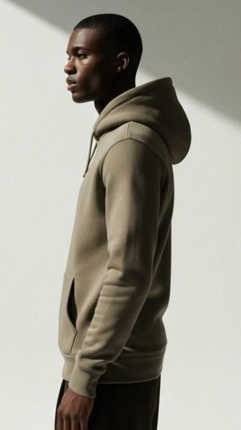 Man wearing a beige hoodie against a plain background