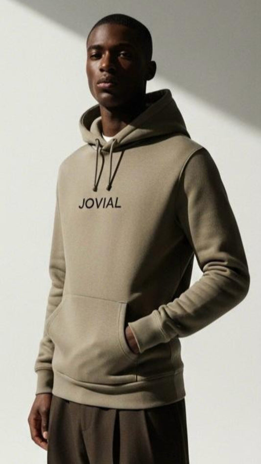 Man wearing a beige hoodie with 'JOVAL' branding against a plain background