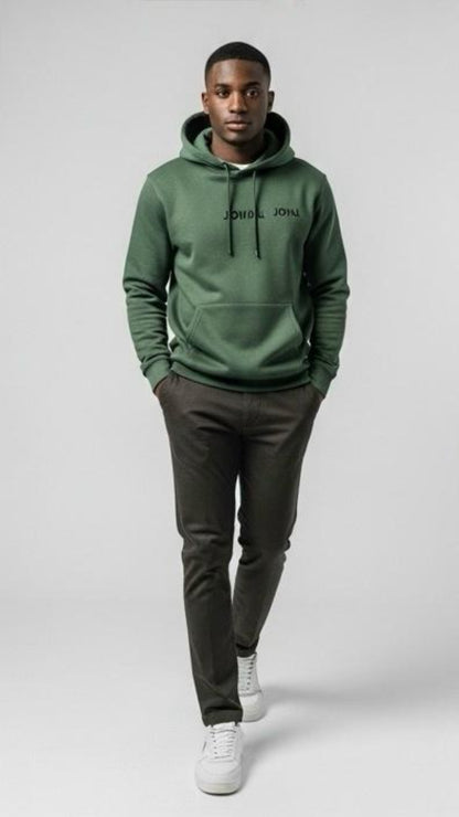Person wearing a green hoodie with 'John John' branding on a white background