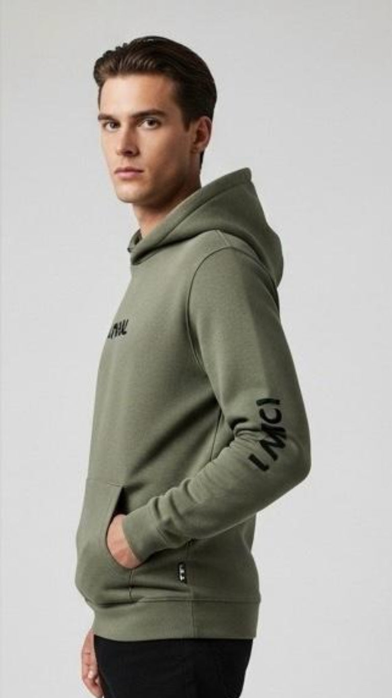 Man wearing a green hoodie with text on sleeves against a white background