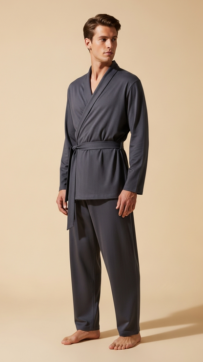 Man wearing a dark gray robe and pants on a beige background