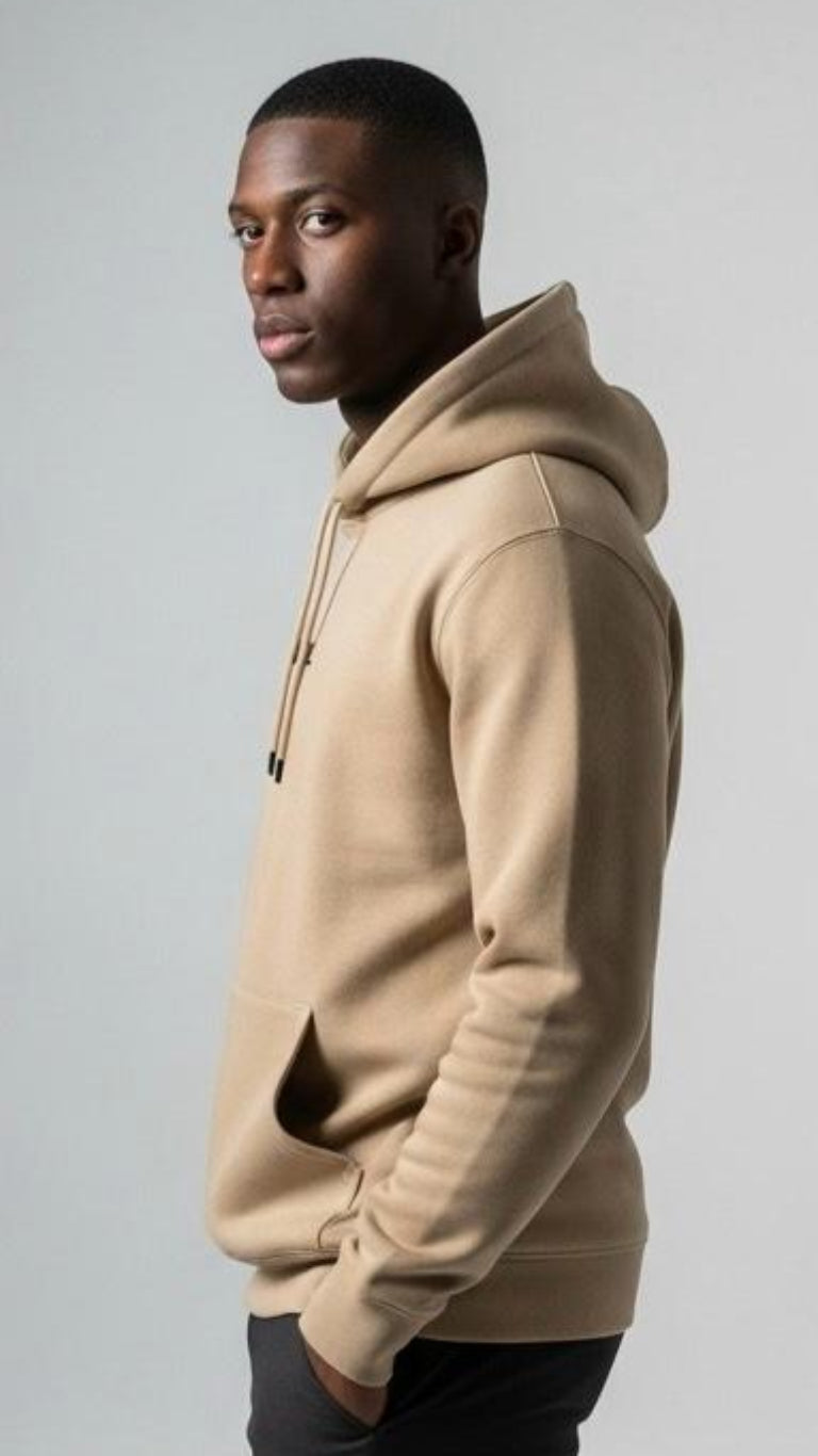 Man wearing a beige hoodie against a plain background