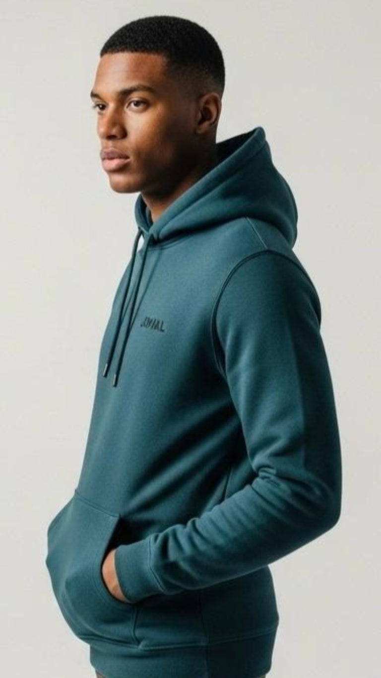 Man wearing a teal hoodie with 'JOVAIL' logo on a light gray background