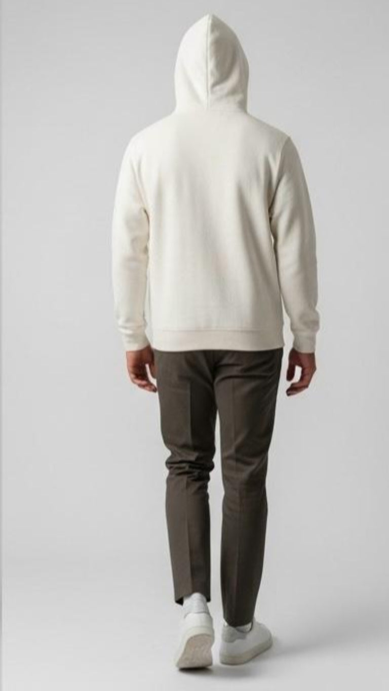 Person wearing a white hoodie and dark pants on a light gray background
