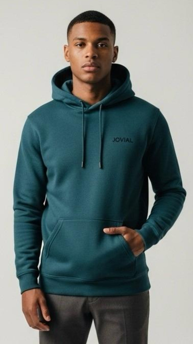 Man wearing a teal hoodie with 'JOVIAL' logo on a light gray background